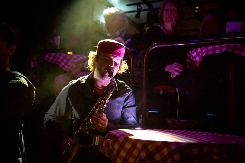 Axel Mårdsjö som Casella, han spelar saxofon bland publiken.