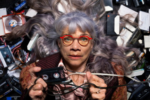 Skådespelaren Iwa Boman ligger på en bädd av kassettband 