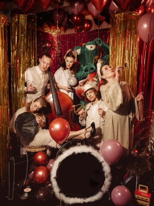 Fem personer omgivna av ballonger och glitter